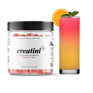 Creatini gummies container next to a colorful cocktail with an orange slice and mint leaf. Miami - Vice Flavor