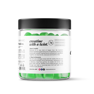 Creatine gummies container next to a green cocktail with green apple slices garnishing on a white background