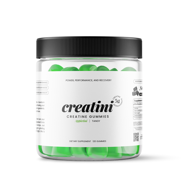 Creatine gummies container next to a green cocktail with green apple slices garnishing on a white background